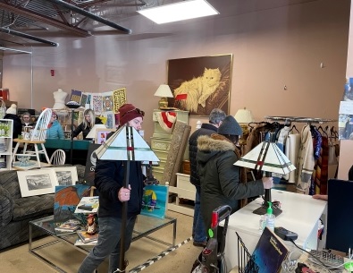 People standing in checkout line with Tiffany lamps