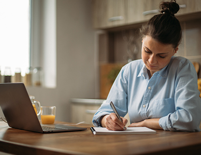 Woman making a shopping list to buy used items