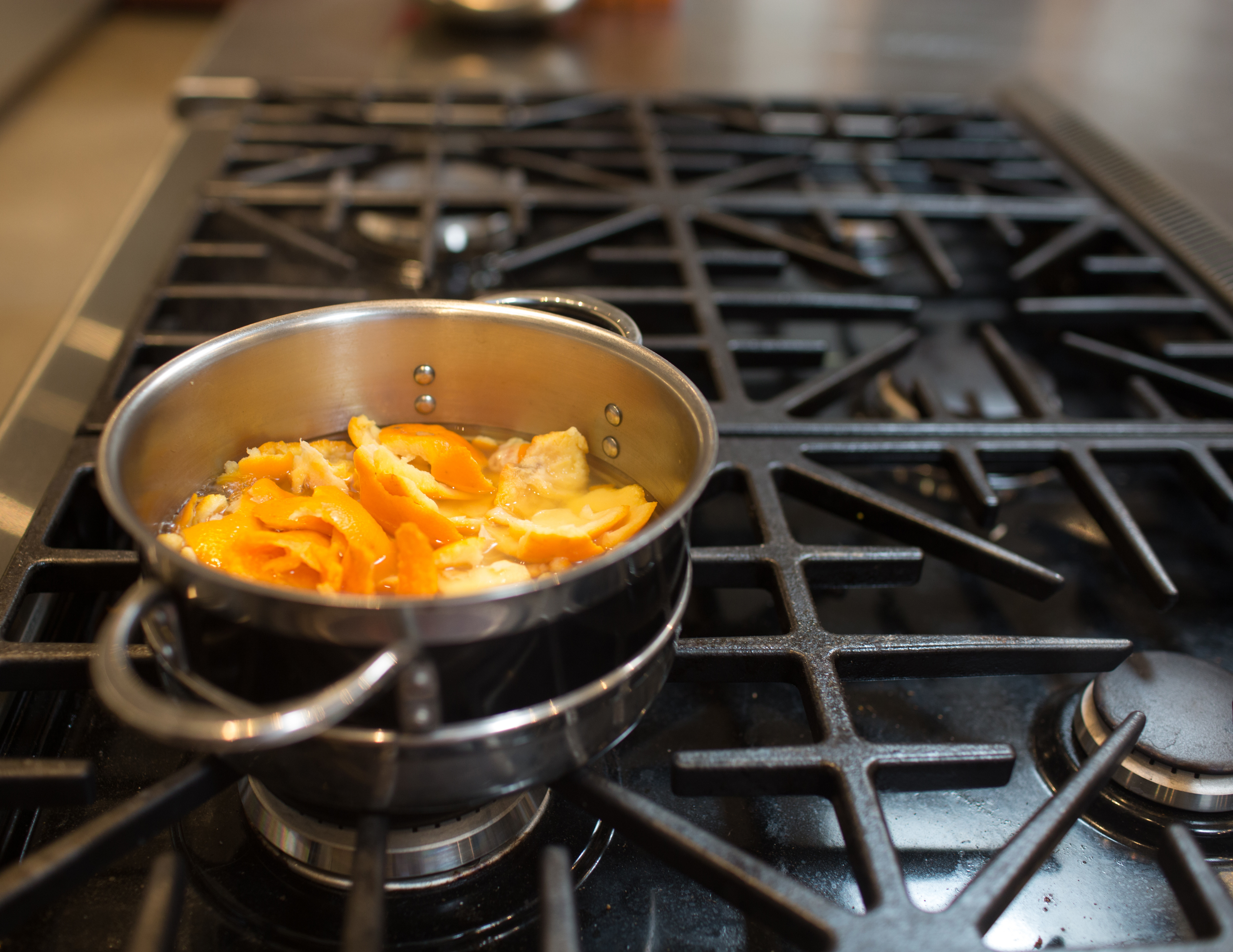 Orange peels simmering on a stove